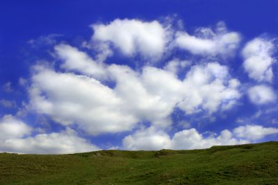 Fluffy white clouds over a blue sky